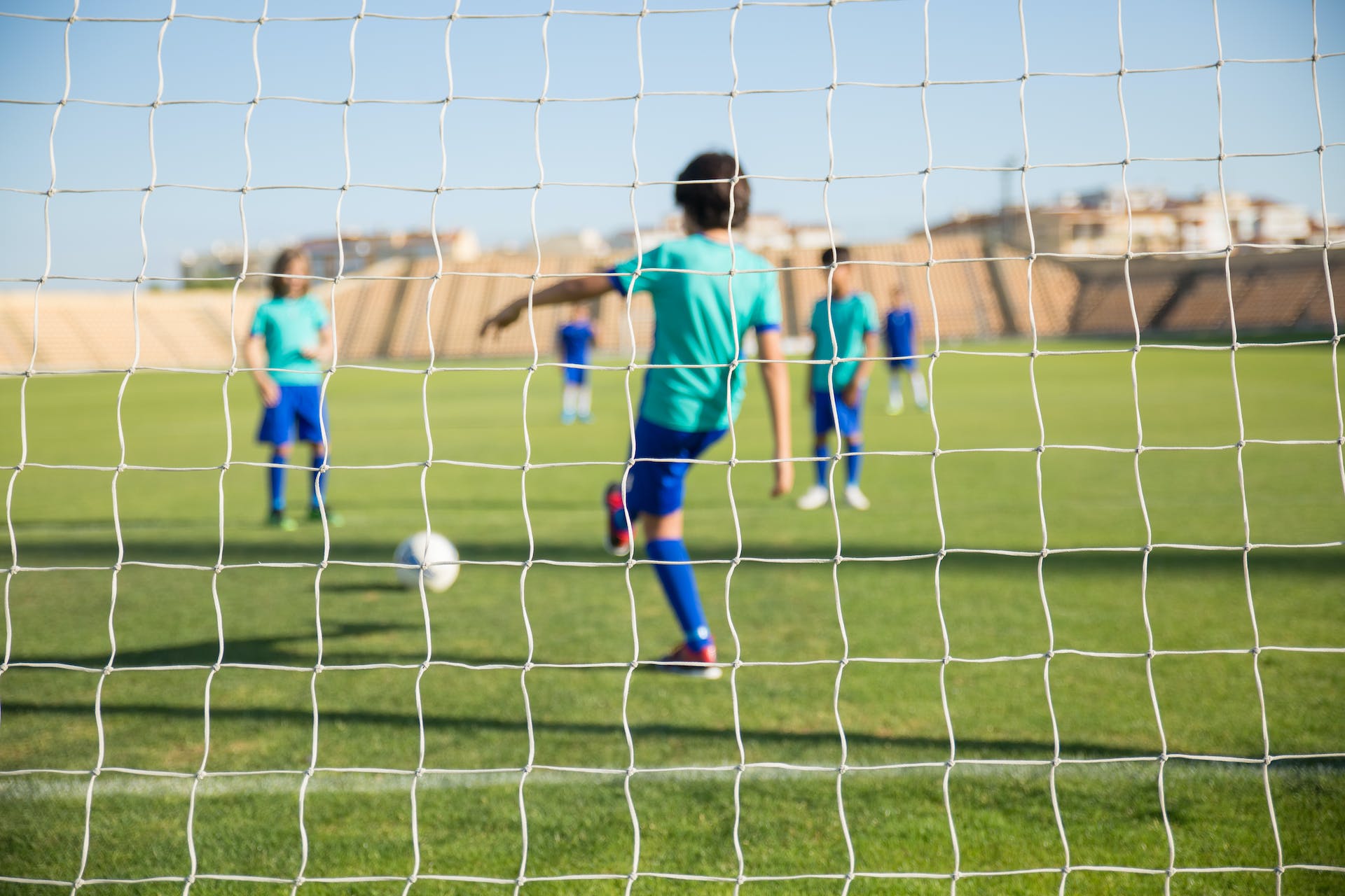 Children playing soccer one of their schools sports which benefits the children