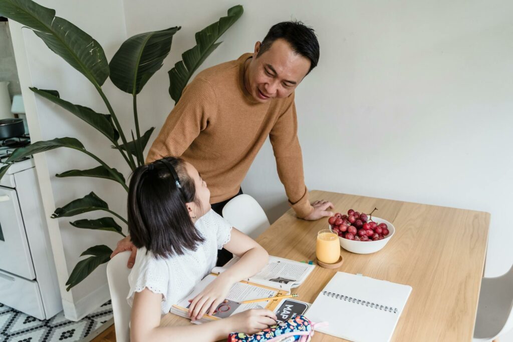 A parent helping their child with homework, this is an important form of parent involvement