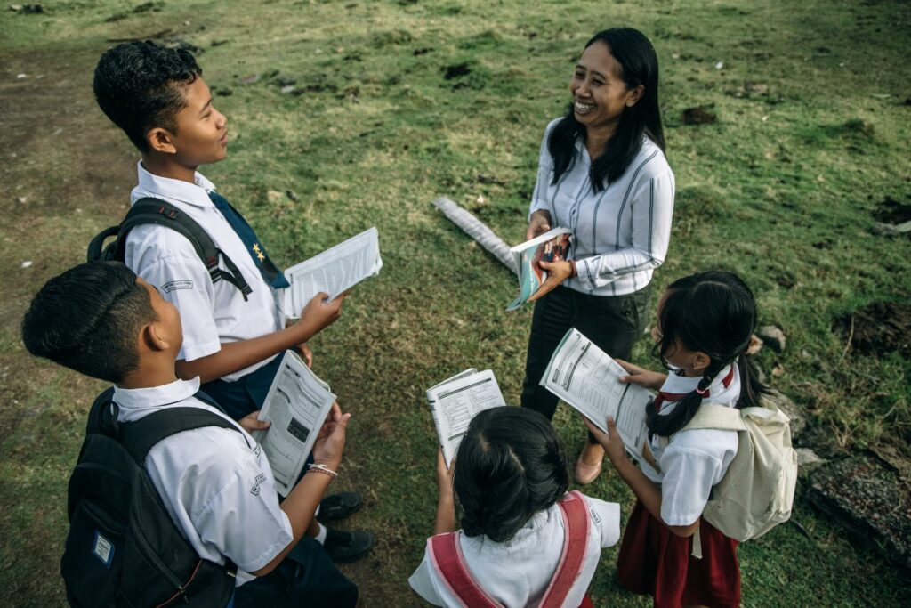 A teacher and students out on educational outings engaging with students