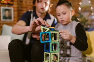 A child playing with building blocks, this is a proven mode of play-based learning