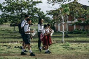 Students and their teacher taking part in a nature walk, which is a form of outdoor learning